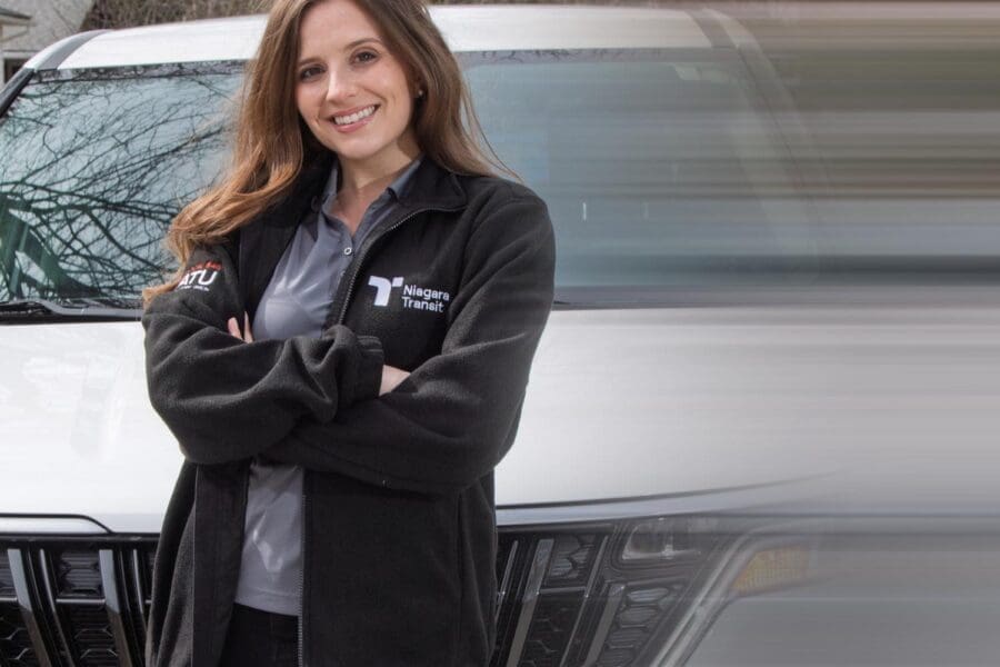 Niagara Transit Plus driver standing in front of vehicle.